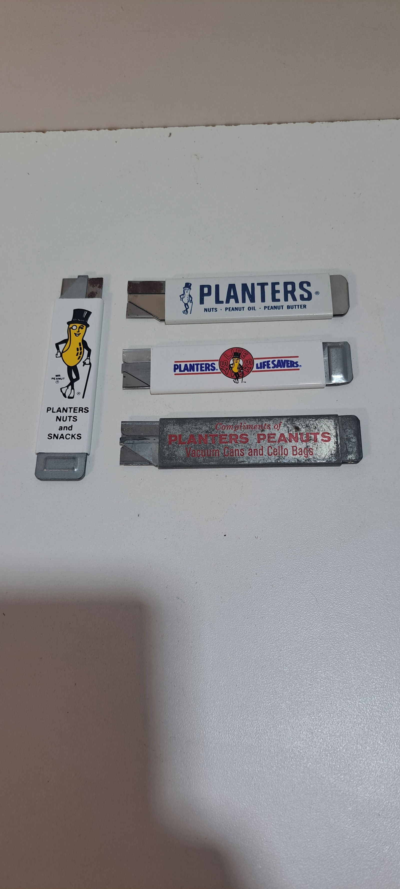 4 Planters Peanuts box cutters: 4 different Planters Peanuts box cutters, good condition, each approx. 4" long,, Please note: if picking up, location is different than auction location. Please contact us for options