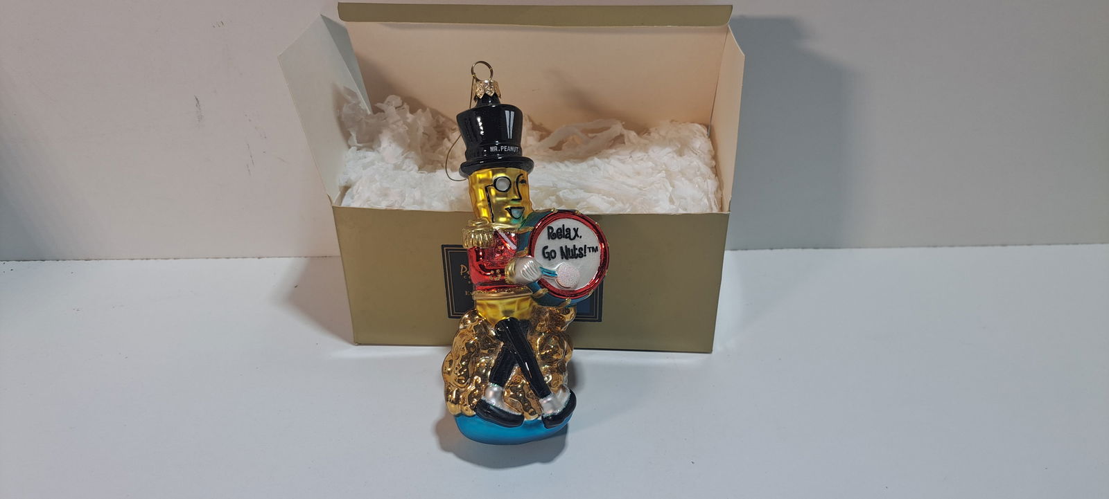 Mr. Peanut ornament: Kurt Adler, Polonaise collection, Mr. Peanut Christmas ornament in box, very good condition, approx. 7", Please note: if picking up, location is different than auction location. Please contact us for