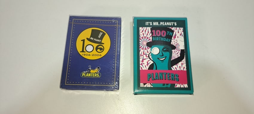 (2) sets Planters Peanuts playing cards: 2 sets of Planters Peanuts/Mr. Peanut 100 year anniversary playing cards, one deck still sealed in plastic, both in excellent condition, Please note: if picking up, location is different than auction