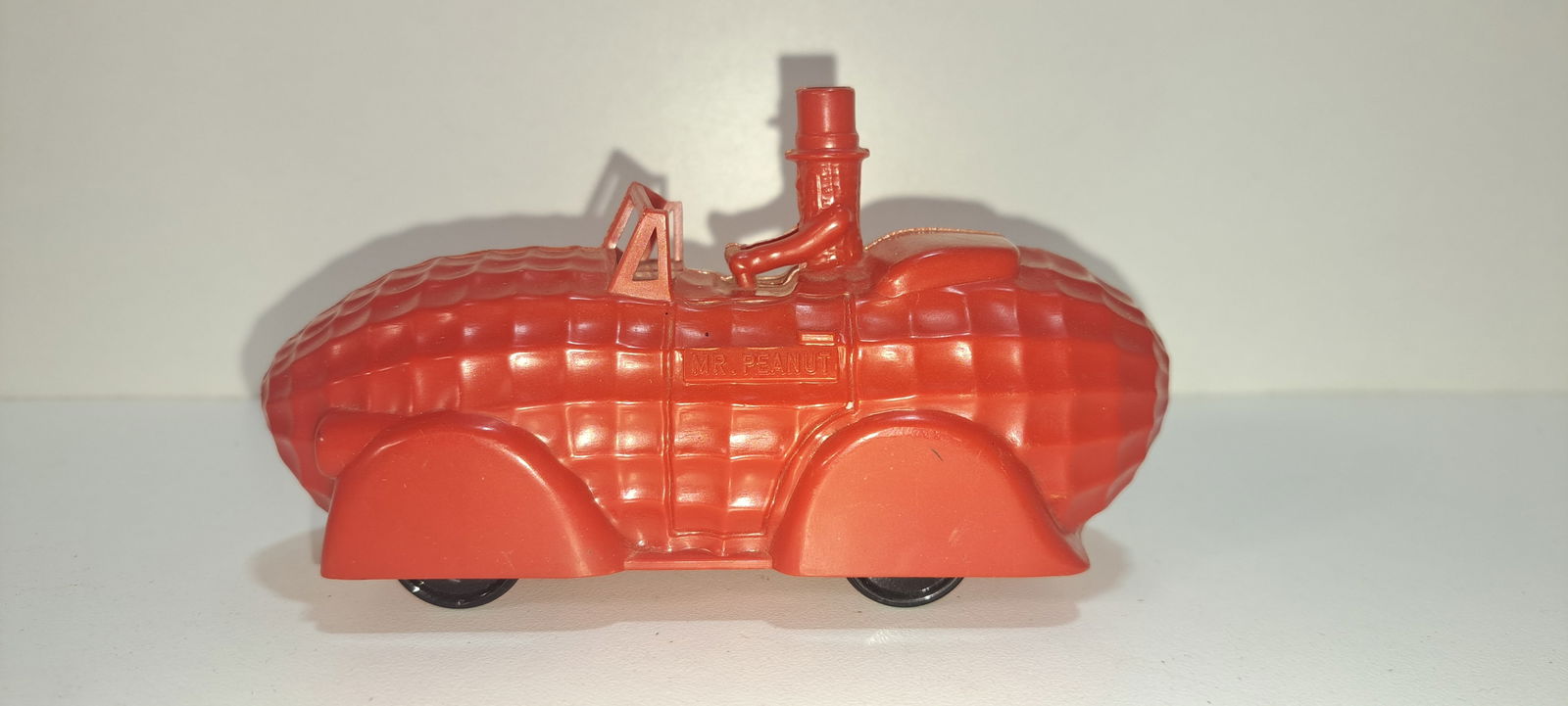 red peanut shaped car Planters: red, plastic, peanut shaped car with Mr. Peanut driving, very good condition with no chips or cracks, approx. 5" long, Please note: if picking up, location is different than auction location. Please c