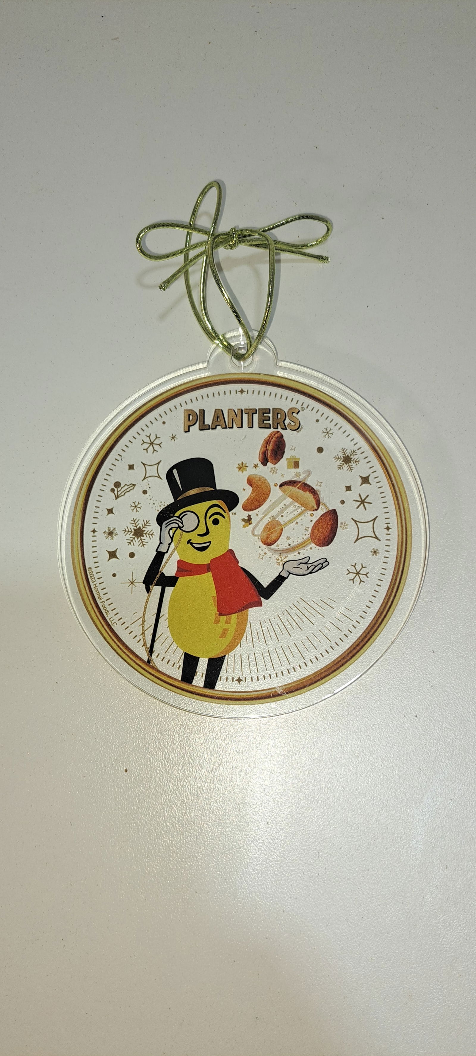 Mr. Peanut Christmas ornament: round, clear acrylic Planters Peanuts Christmas ornament, excellent condition, approx. 4" diameter, Please note: if picking up, location is different than auction location. Please contact us for optio