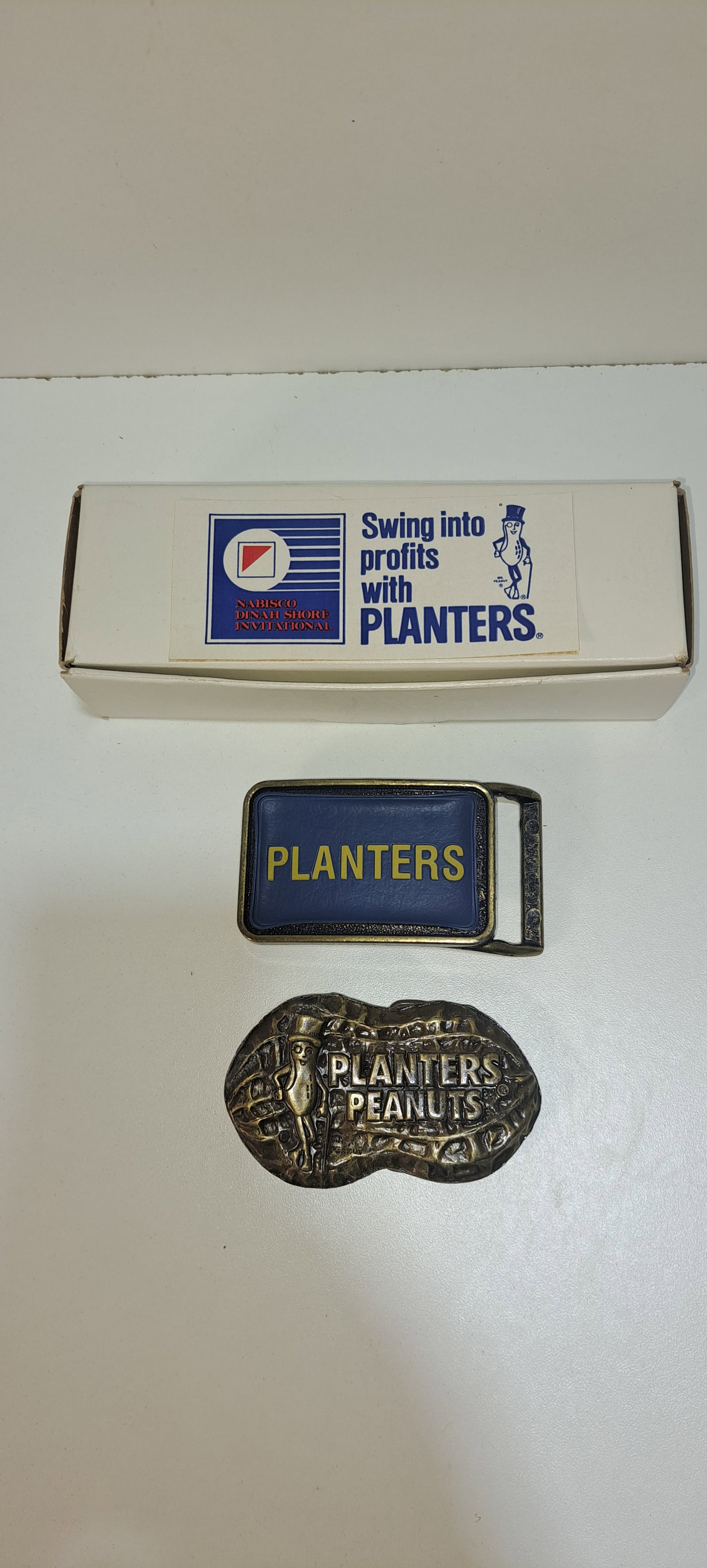 Mr. Peanut belt and 2 buckles: Mr. Peanut belt and buckle new in box and 2 Planters Peanuts belt buckles, all in good condition, Please note: if picking up, location is different than auction location. Please contact us for options