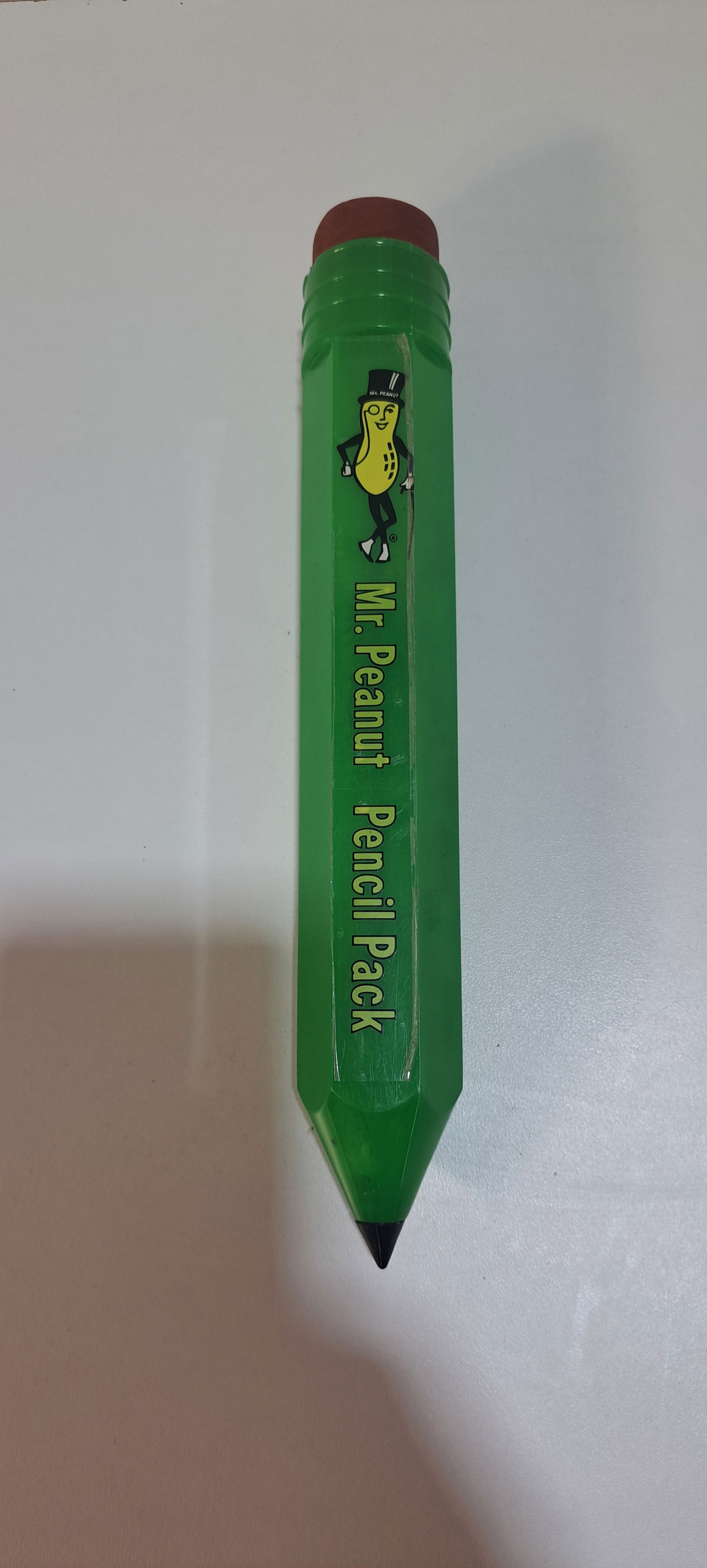 Mr. Peanut pencil pack: green, plastic, pencil shaped, Mr. Peanut pencil pack with 8 unused Mr. Peanut pencils, a few cracks at top of case, approx. 10" long, Please note: if picking up, location is different than auction