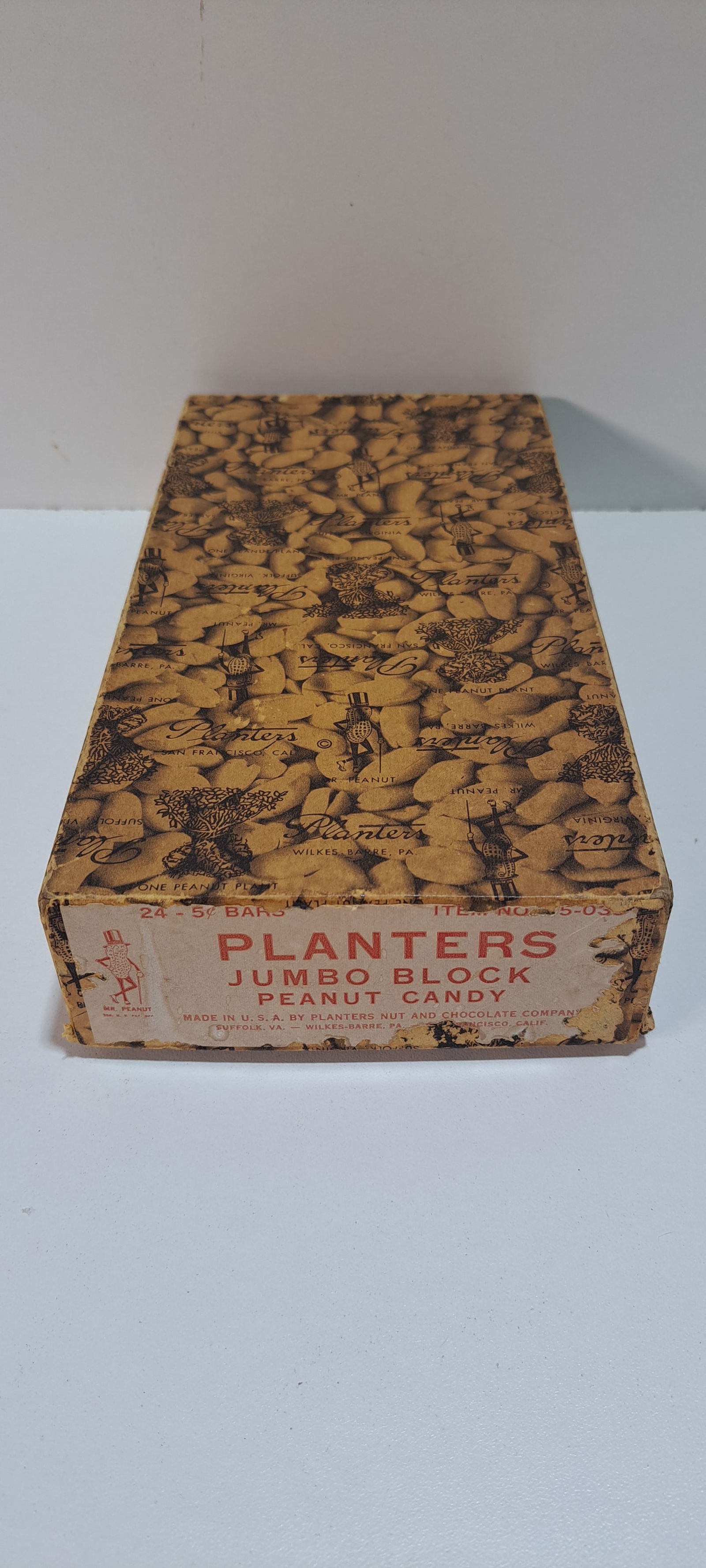 Planters Peanuts box: Planters Peanuts cardboard box with lid, held 24-5 cent jumbo block peanut candy bars, with label, shows peanuts, peanut plants, many Mr. Peanuts, some damage to label, minor wear on box, approx. 5" x