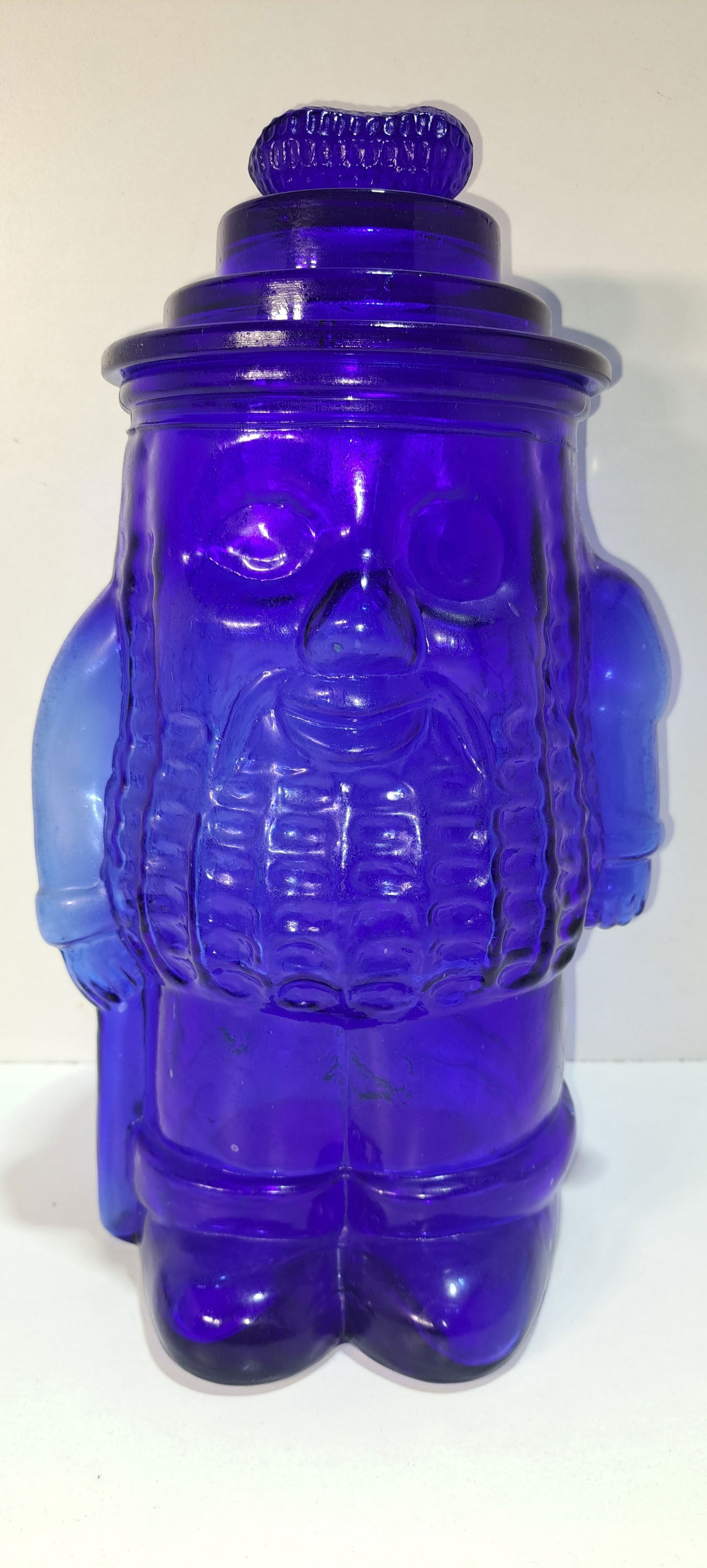 blue Mr. Peanut glass jar: blue glass jar made in the image of Mr. Peanut, with lid, peanut shaped handle, this is an older fantasy jar, not original, minor roughness on inside edge of jar, otherwise good condition, approx.