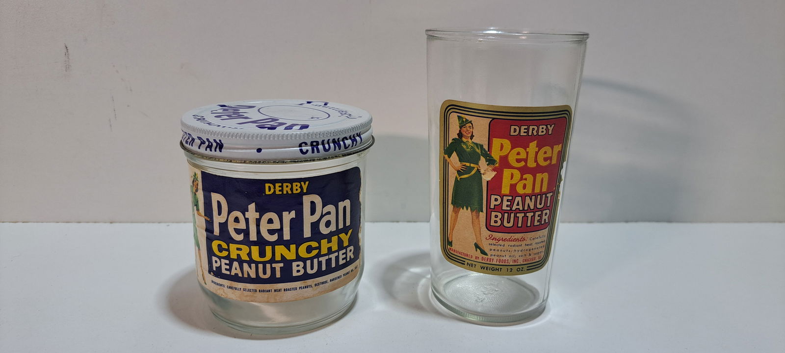 Peter Pan peanut butter jar and glass: Peter Pan peanut butter jar with paper label and metal screw on lid, minor wear, held 12 oz., approx. 3.5" tall, Peter Pan peanut butter glass with paper label, minor wear to label, held 12 oz.,