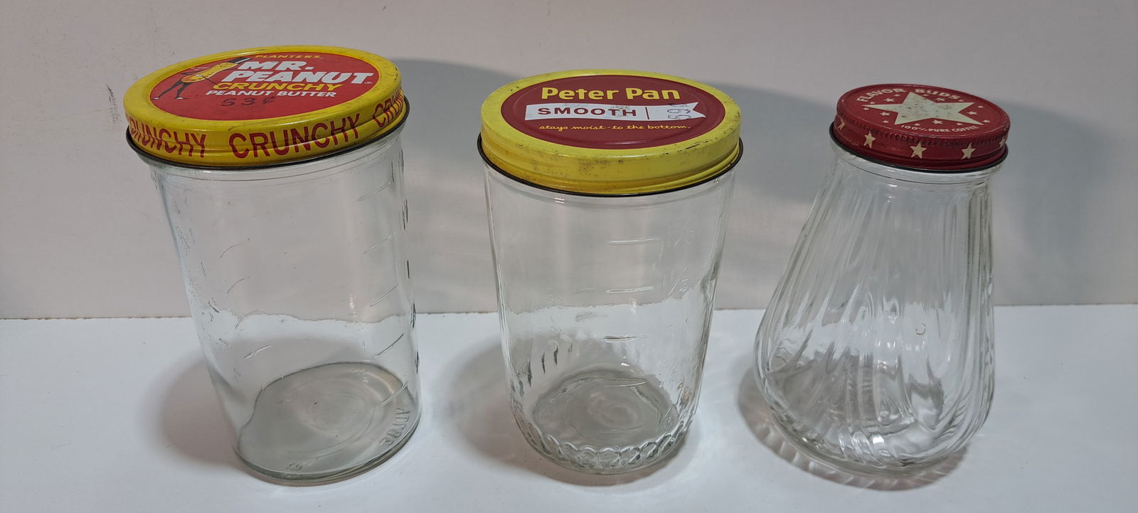 3 glass jars: lot of 3 glass jars with metal screw on lids, 1 Mr. Peanut crunchy peanut butter, also a measuring glass, approx. 5.5" tall, 1 Peter Pan smooth peanut butter, also a measuring glass, approx. 5.25"