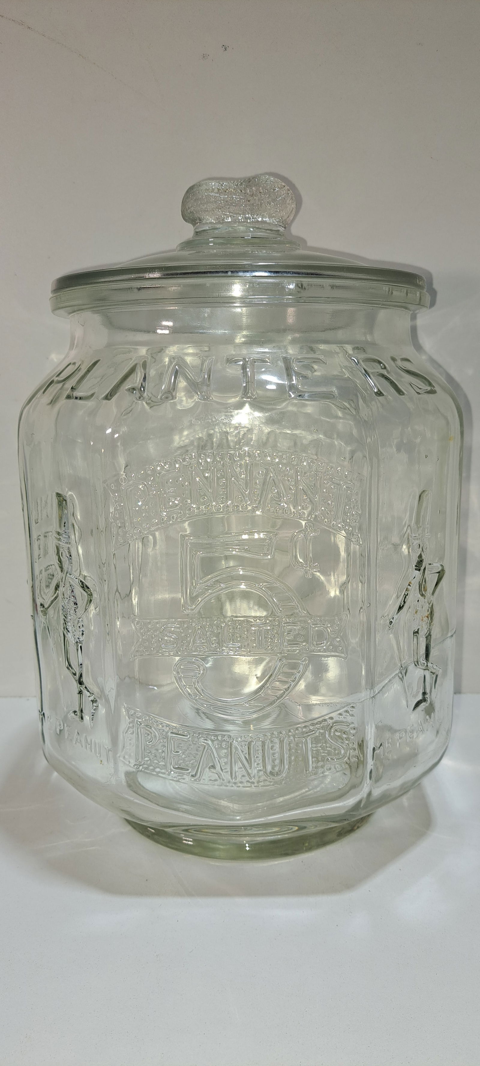 Planter Peanuts 8 sided glass jar: Planters Peanuts, 8 sided counter top, glass jar, correct lid with peanut shaped handle, embossed on 7 sides, Made In USA on bottom, this is an original jar not a reproduction, has some roughness on i