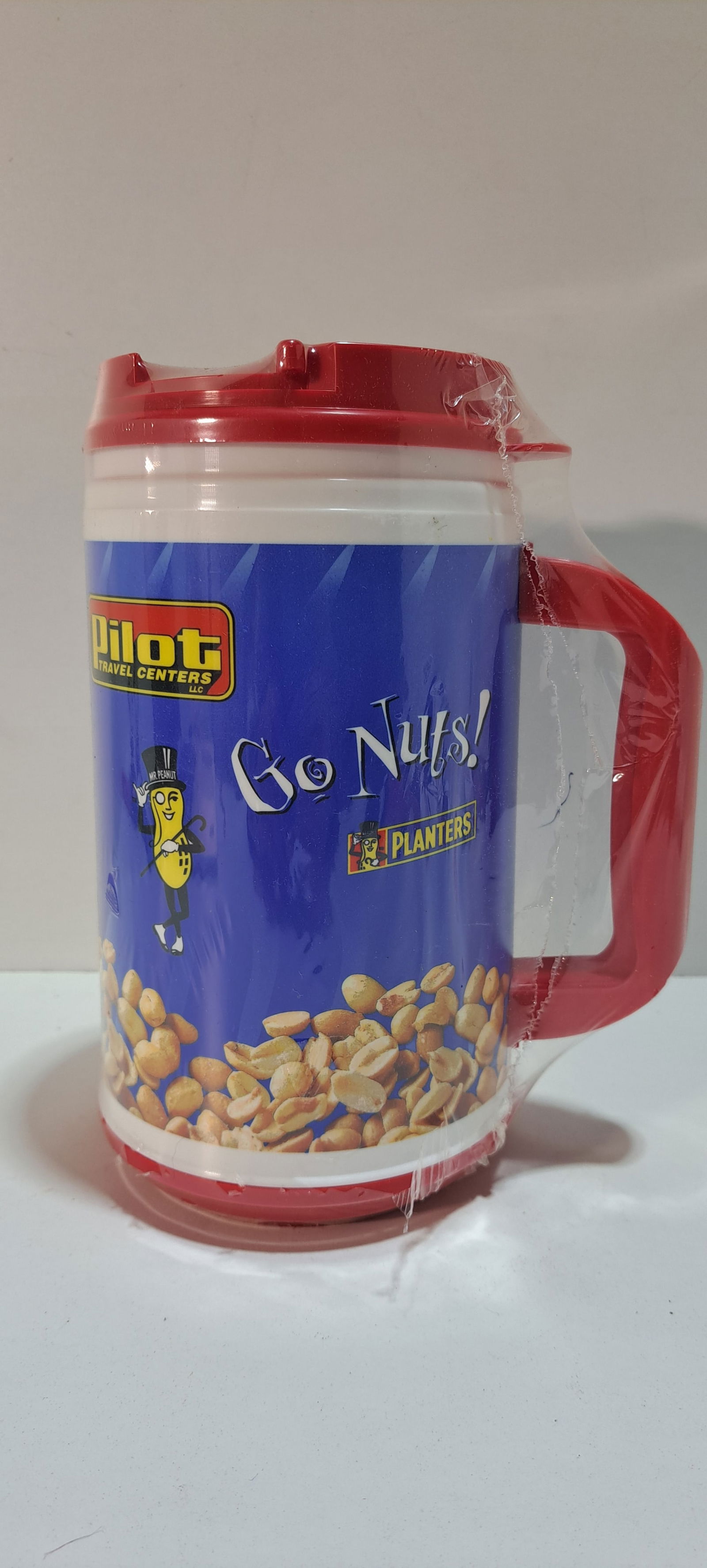 Mr. Peanut travel mug: large, plastic, travel mug, Mr. Peanut, Go Nuts!, Pilot travel centers, still wrapped in plastic, approx. 8.5" tall, Please note: if picking up, location is different than auction location. Please