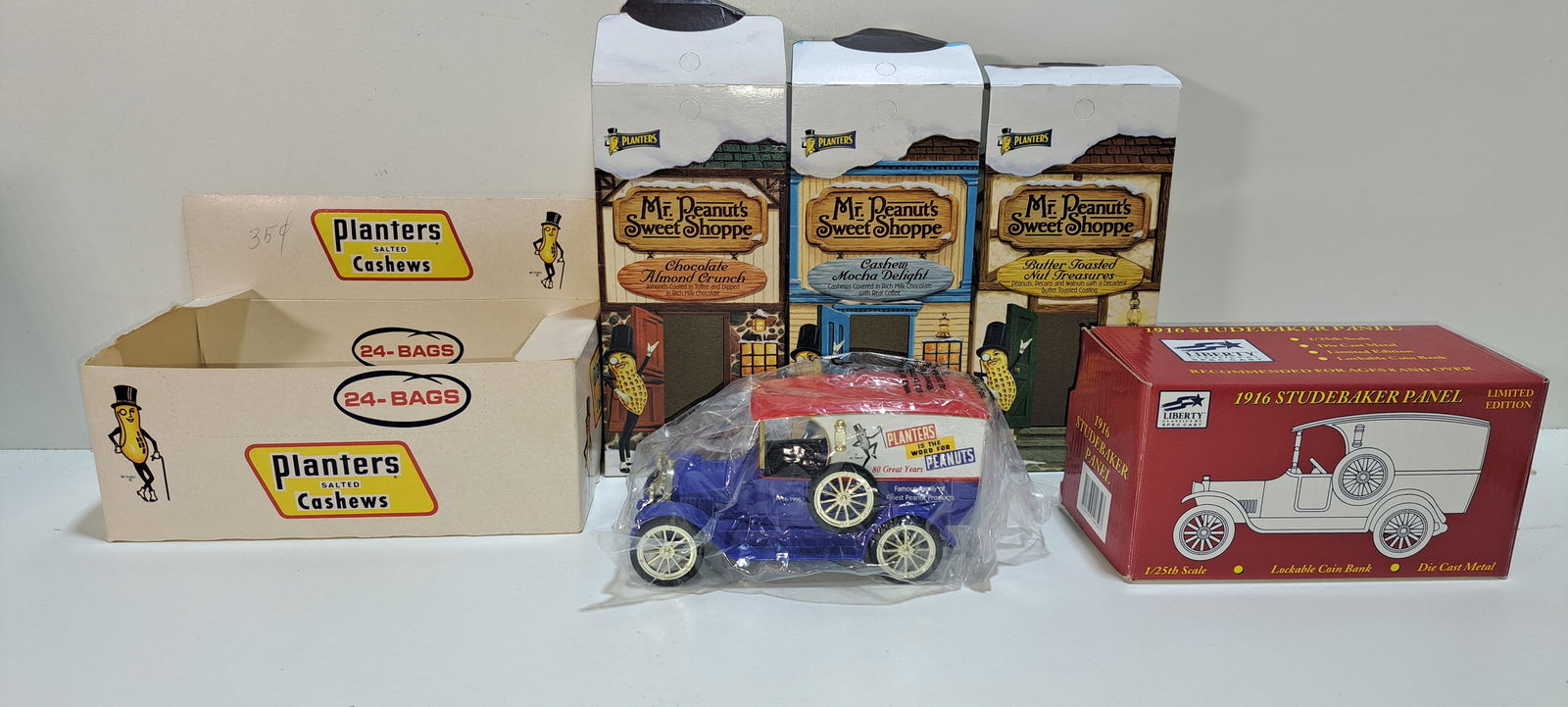 Planters Peanuts lot: Planters Peanuts collectible lot consisting of: 1 die cast 1916 Studebaker truck new in box, 3 Mr. Peanut's Sweet Shoppe cardboard boxes, 1 Planters salted cashews, Standard Brands cardboard display