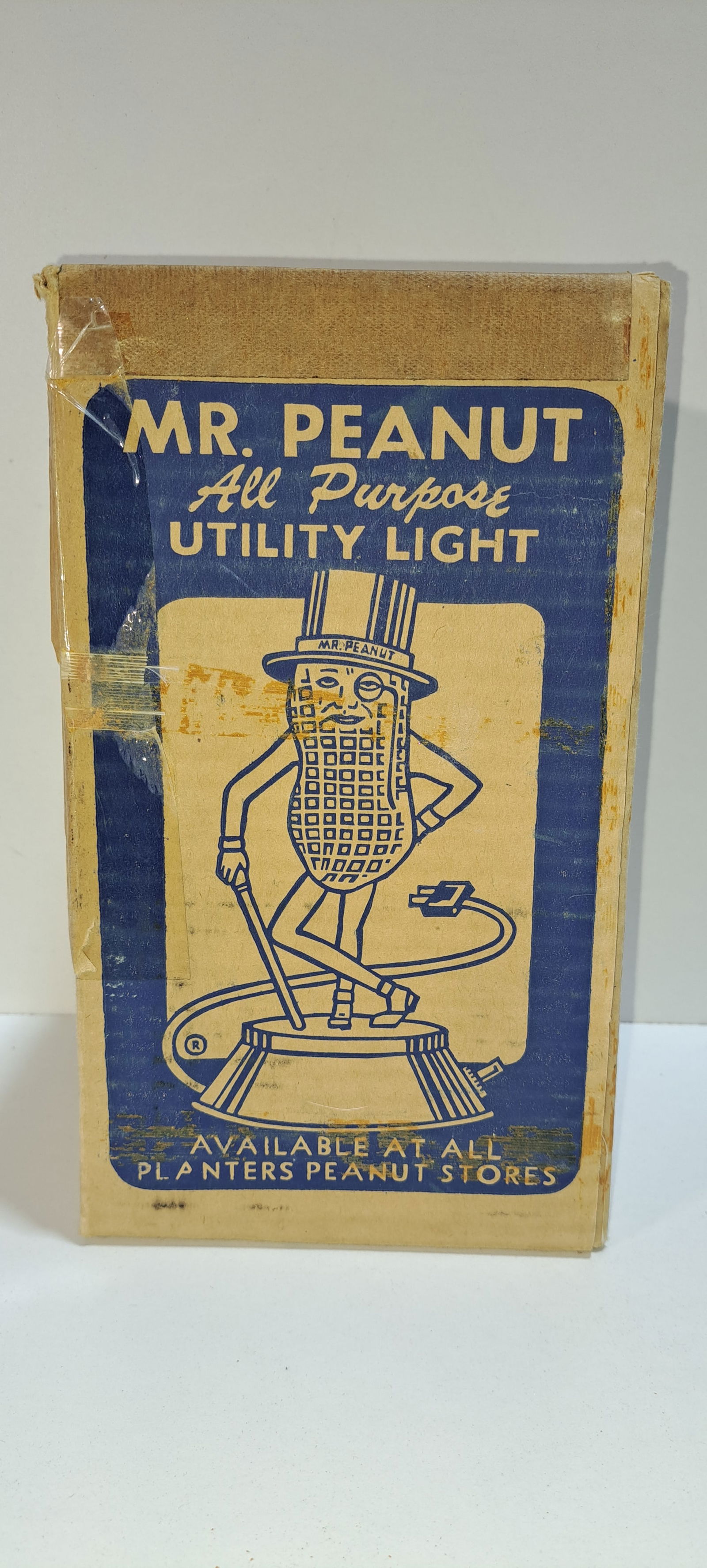 Mr. Peanut utility light box: hard to find, original, cardboard shipping box for the plastic, figural, Mr. Peanut utility(night) light, showing different uses for the light, box shows wear primarily from tape removal at some point