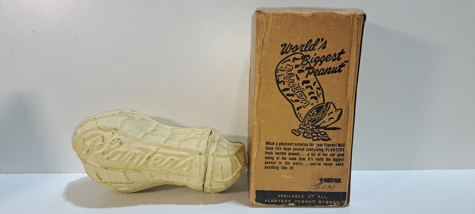 Planters paper mache peanut in box: Planters Peanuts, paper mache peanut shaped container that held 1 lb. of peanuts, embossed PLANTERS, in original cardboard shipping box, with souvenir of Atlantic City sticker, peanut and box have wea