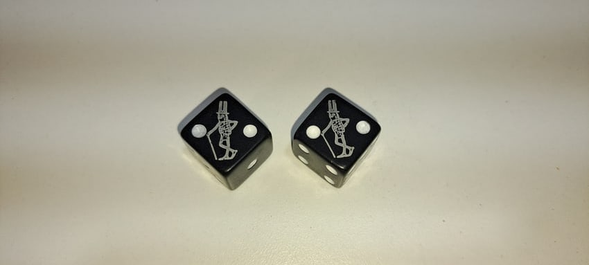 pair of Mr. Peanut dice: pair of black dice with Mr. Peanut in silver, good condition, approx. .75" square, Please note: if picking up, location is different than auction location. Please contact us for options.
