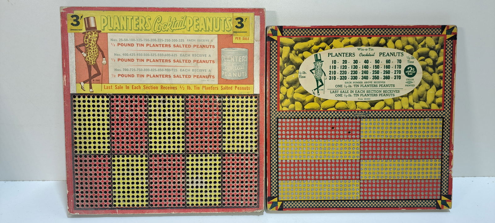 (2) Planters Peanuts punchboards: 2 different, Planters Peanuts punchboards, larger one has been punched, smaller one has two holes punched, both missing punch on back, both show some wear, one approx. 9.5" x 10" , other 9.25" x 9",