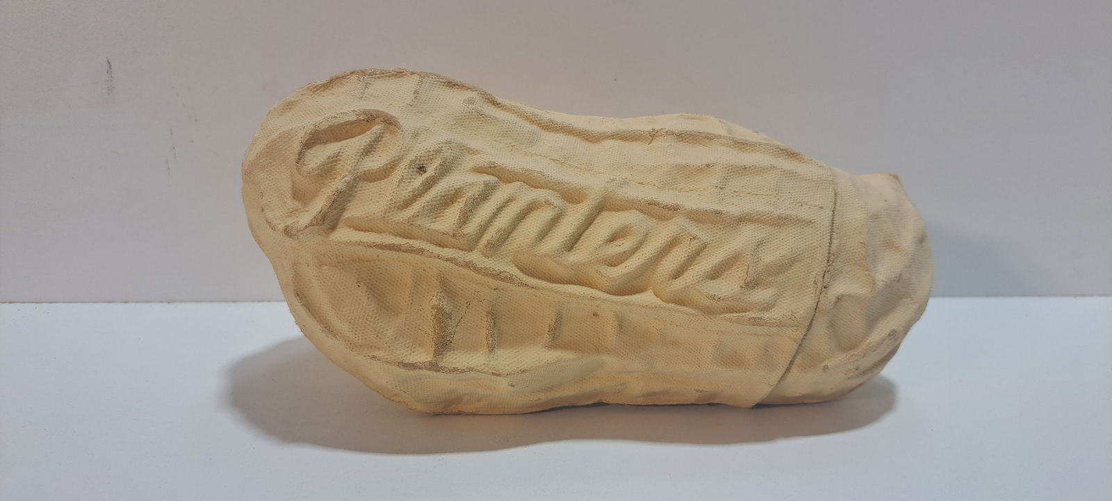 Planters Peanut 1/2 lb. peanut container: paper mache, peanut shaped container, held 1/2 lb. of Planters Peanuts, heavily embossed, light wear, overall good condition, approx. 9" long, Please note: if picking up, location is different than