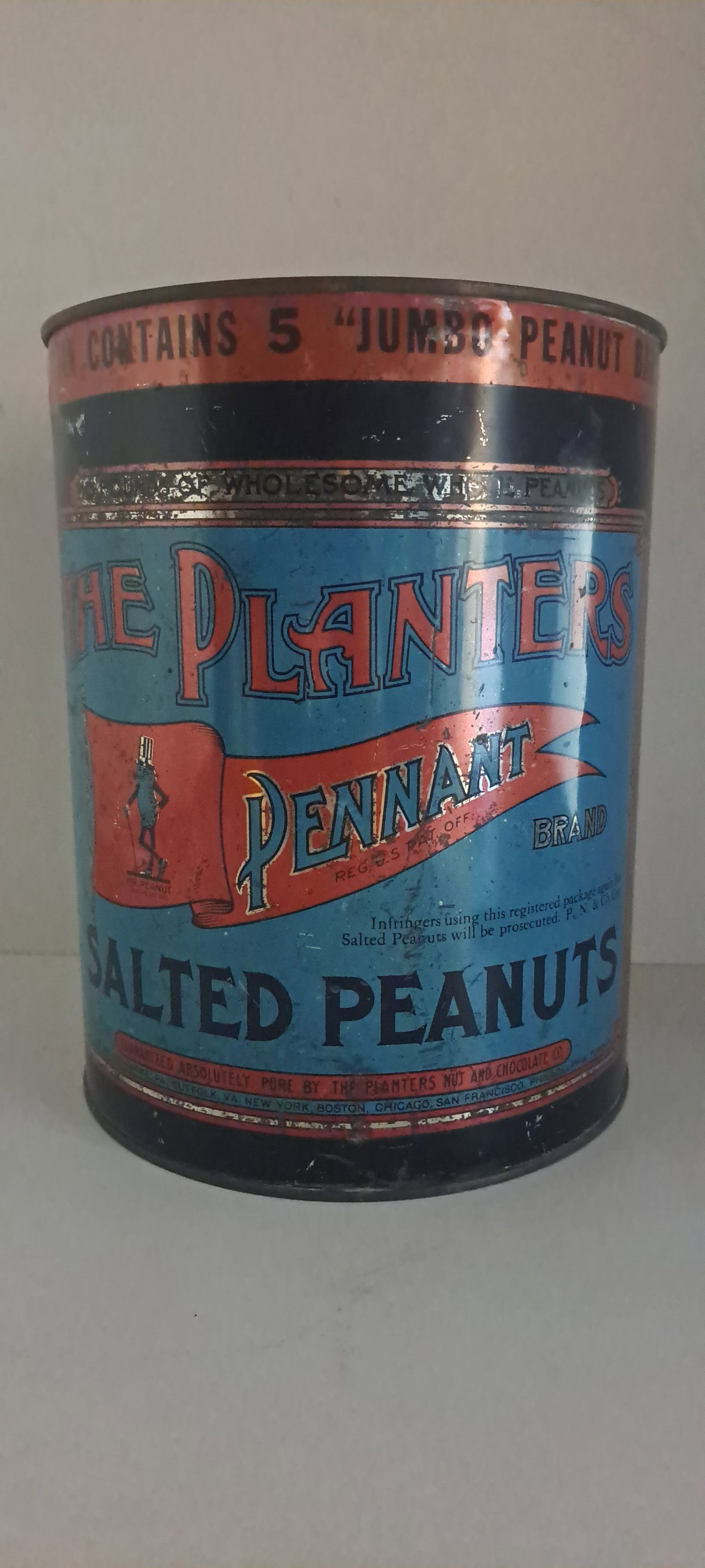 Planters Peanuts 10 lb. tin: Planters Peanuts 10lb. Pennant brand tin. Harder version to find with red banner at top advertising 5 jumbo peanut bars included for free. Has correct lid. Tin shows minor wear, very clean lid. Approx