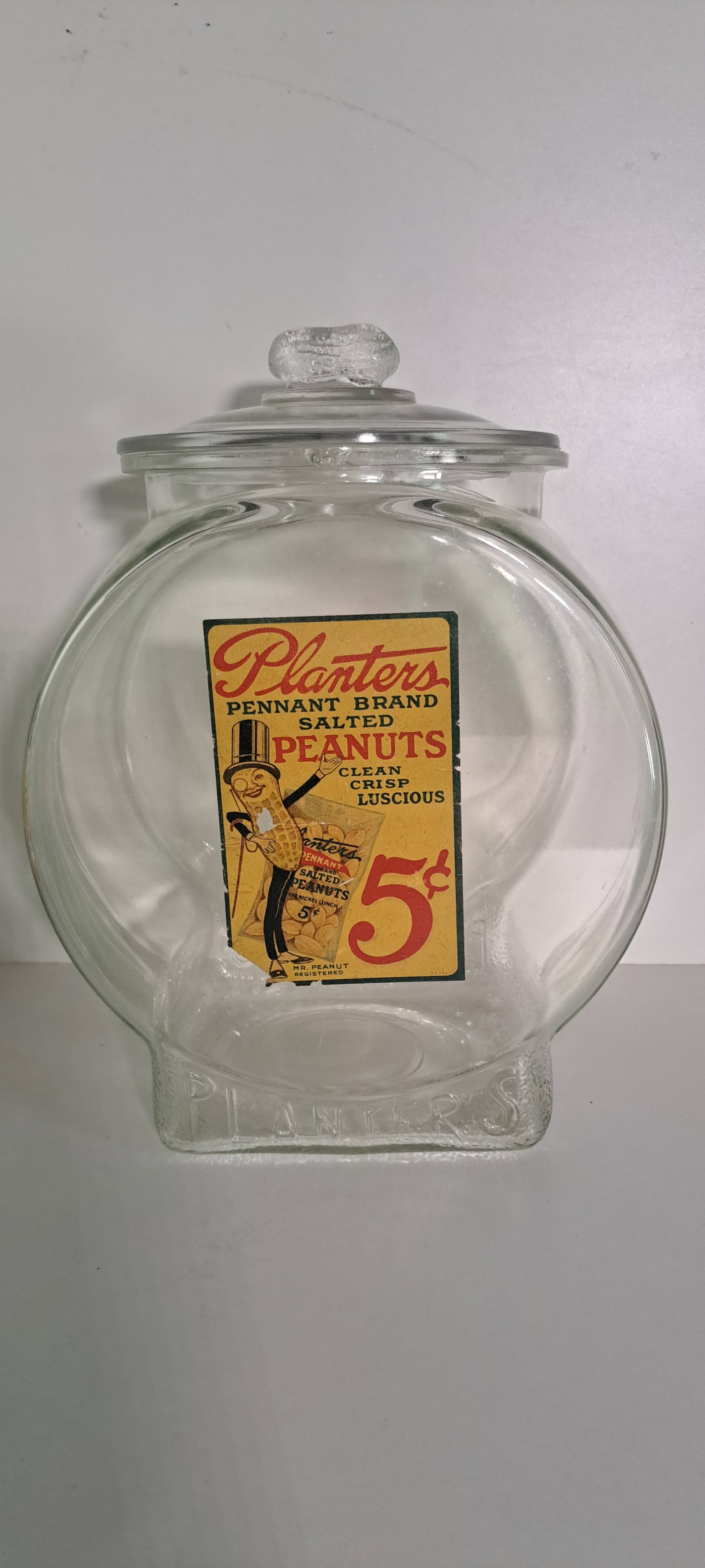 Planters Peanuts fishbowl jar: Large, Planters Peanuts, fishbowl, glass, counter jar, with label and peanut shaped handle on lid. This is an original jar, not a reproduction. Label has some damage, chips on rim of jar and lid.