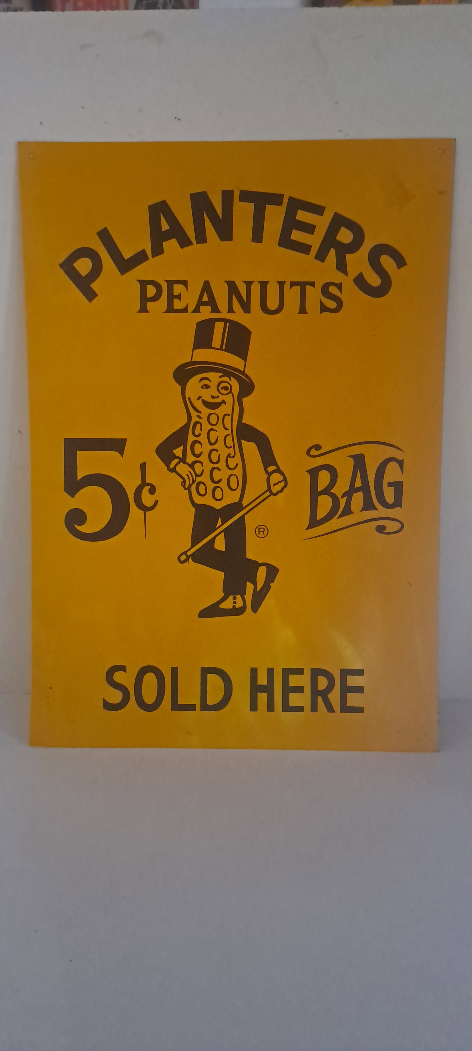 Planters Peanuts tin sign: Planters Peanuts, single sided, tin sign, with Mr. Peanut. has two holes to hang. Minor wear, small crease bottom left, strong color. Approx. 14" x 20". Please see our shipping policy for options.