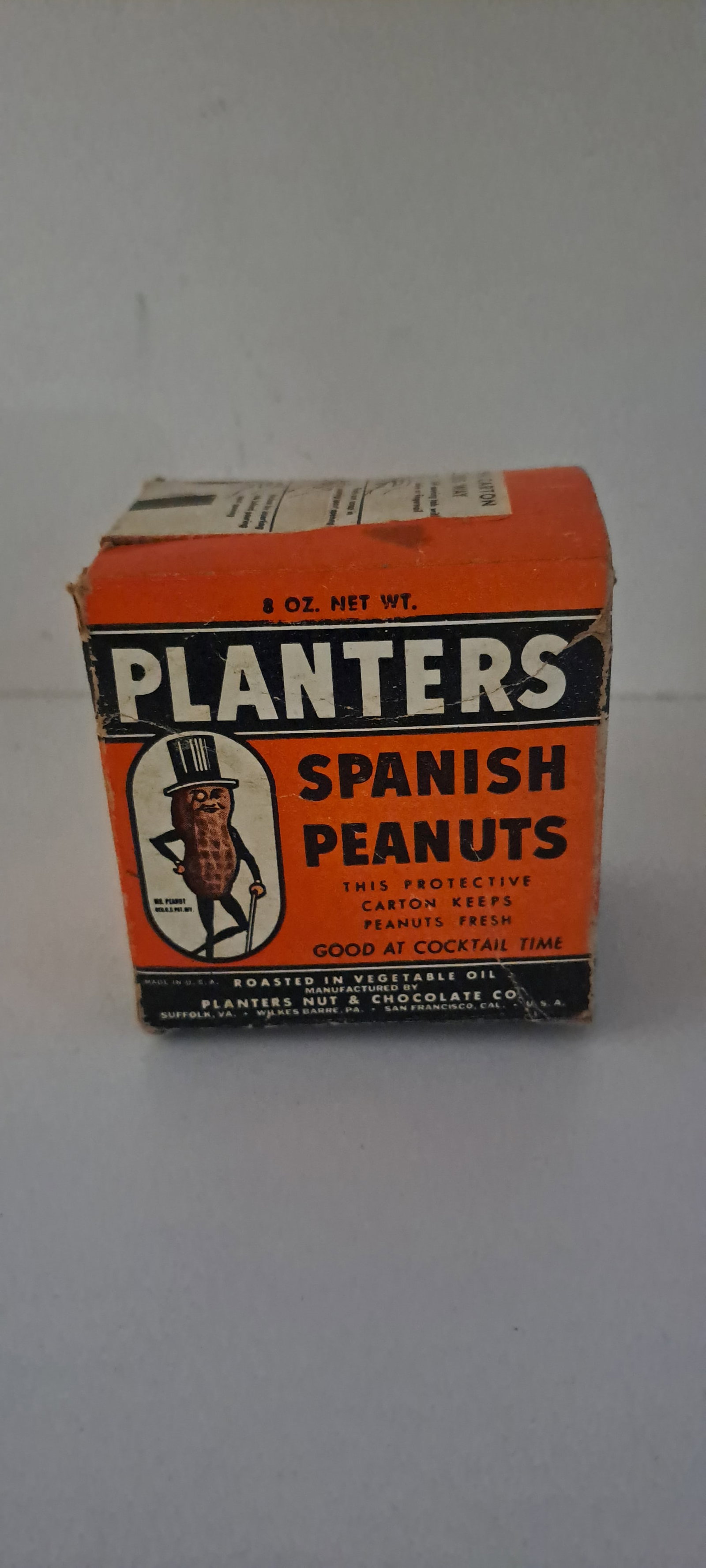 Planters Peanuts box: Small, rare, Planters Spanish Peanuts, cardboard box. Held 8 oz. These were made when metal was being saved for the war effort. Shows early Mr. Peanut. Some damage as shown, strong color. Approx. 2.5"