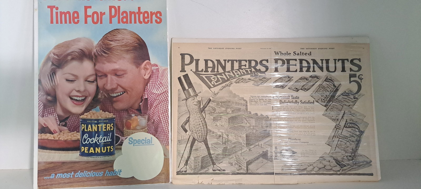 (2) Planters Peanut ads: 1 Saturday Evening Post advertisement from February 15, 1919. Approx. 14" x 20". Shrink wrapped. 1 cardboard advertisement. Approx. 12" x 20". Shrink wrapped. Both advertising Planters Peanuts. Minor