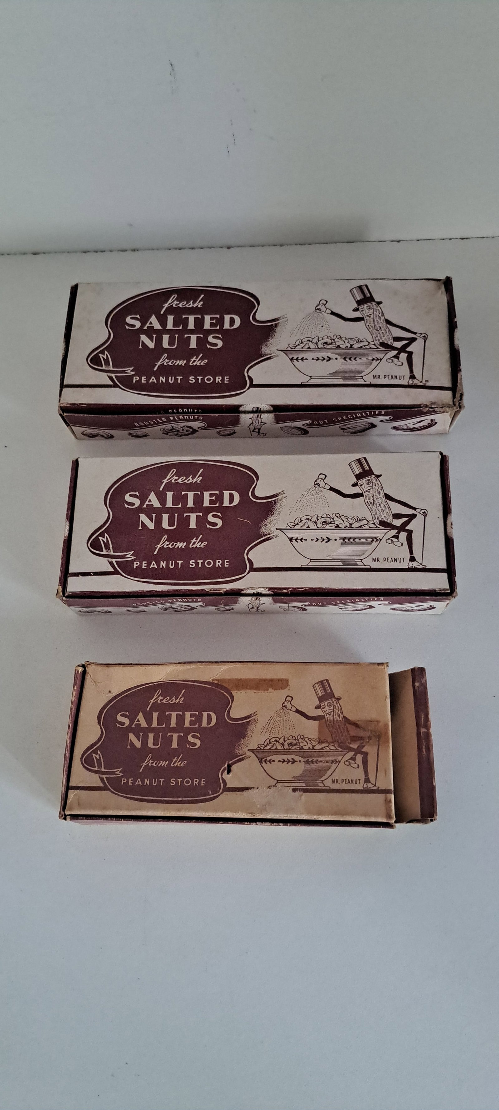 (3) Planters Peanuts boxes: 3 sizes of fresh salted nut boxes from the Peanut Store, with Mr. Peanut. 4 ounces, 6 ounces, and half a pound. All show wear. Please see our shipping policy for options.