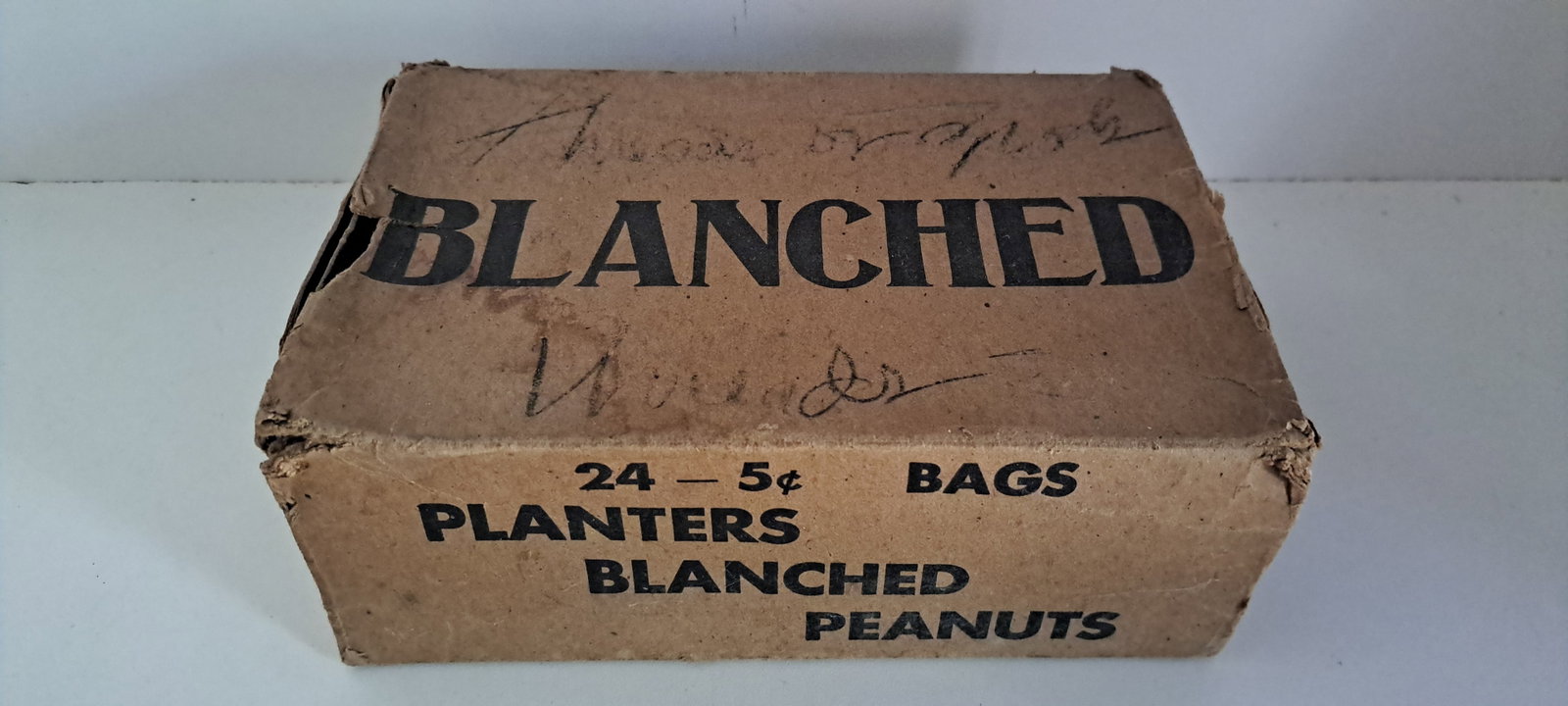 Planters Peanuts box with sleeve: Planters Peanuts cardboard box with outer sleeve. Nice graphics. Box has wear, sleeve is torn and written on. Approx. 5.75" x 8.5" x 3.25". Please see our shipping policy for options.
