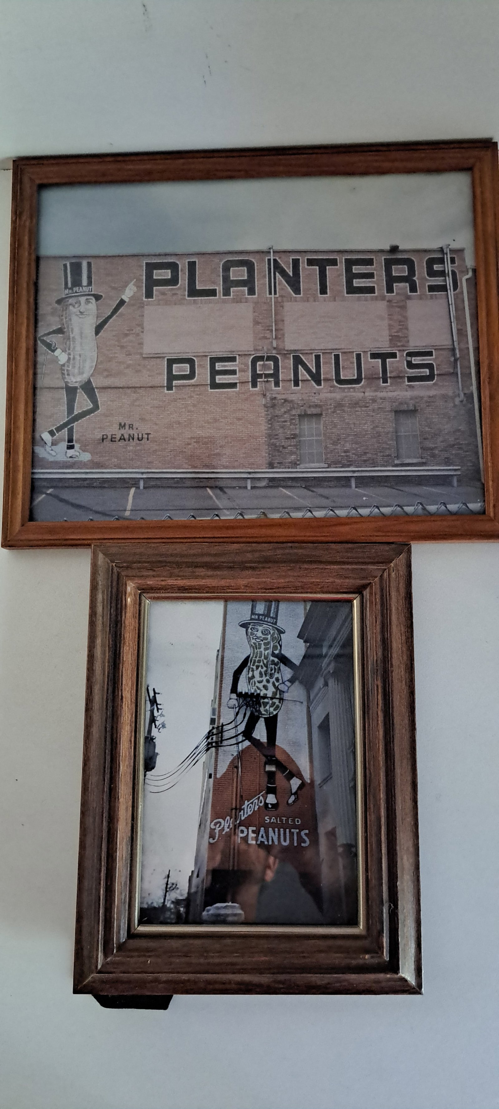 (2) framed Mr. Peanut pictures: 2 framed pictures of Mr. Peanut advertising signs from the Planters Peanuts factory in Wilkes-Barre PA. 1 approx. 5" x 7", 1- 8" x 10". Both in good condition. Please see our shipping policy for