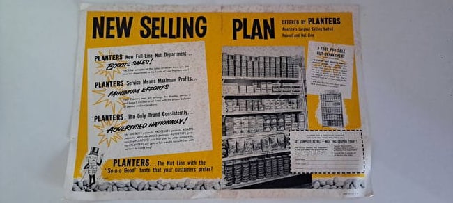 Planters Peanuts new selling plan advertisement: Planters Peanuts paper advertisement for- a New Selling Plan. Shows the Nut Department metal racks full of various product. Has Mr. Peanut on the bottom. Has been folded. Small tears on edges. Some