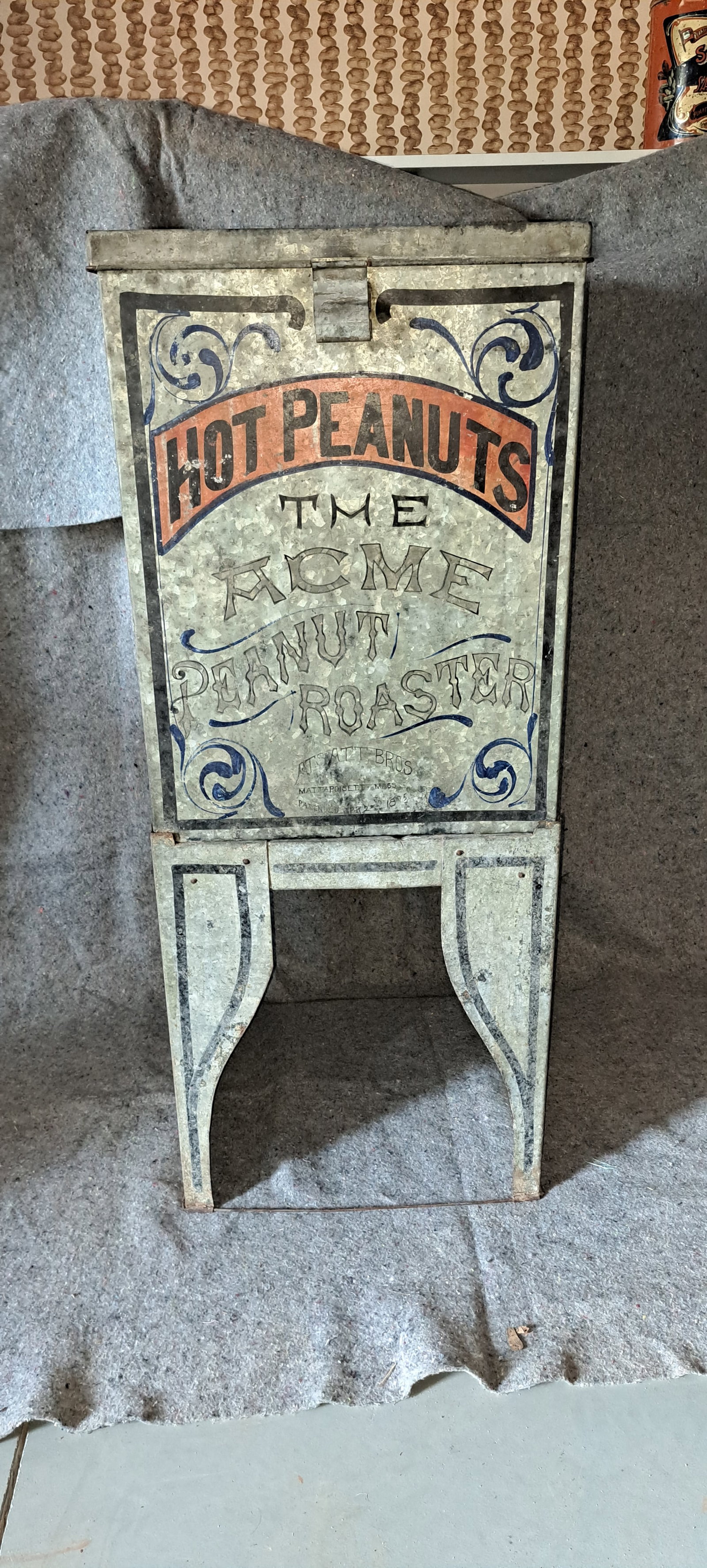 Acme peanut roaster: Acme peanut roaster. Made of galvanized tin. Appears complete. With wire baskets inside. Top is separate from base. Some wear, great original graphics. Approx. 18.5" x 18.5" x 44" tall. ** We can