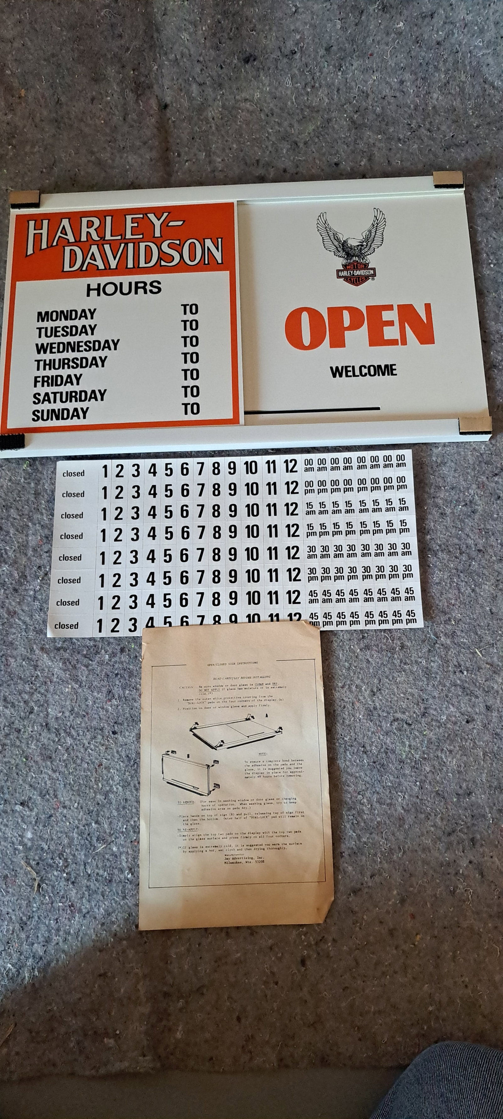Harley Davidson dealership sign: Harley Davidson open and closed sign with hours of operation. New, old stock. Never used, Comes with instructions and stickers to place for hours. Made of plastic, slides to show open or closed. Doubl