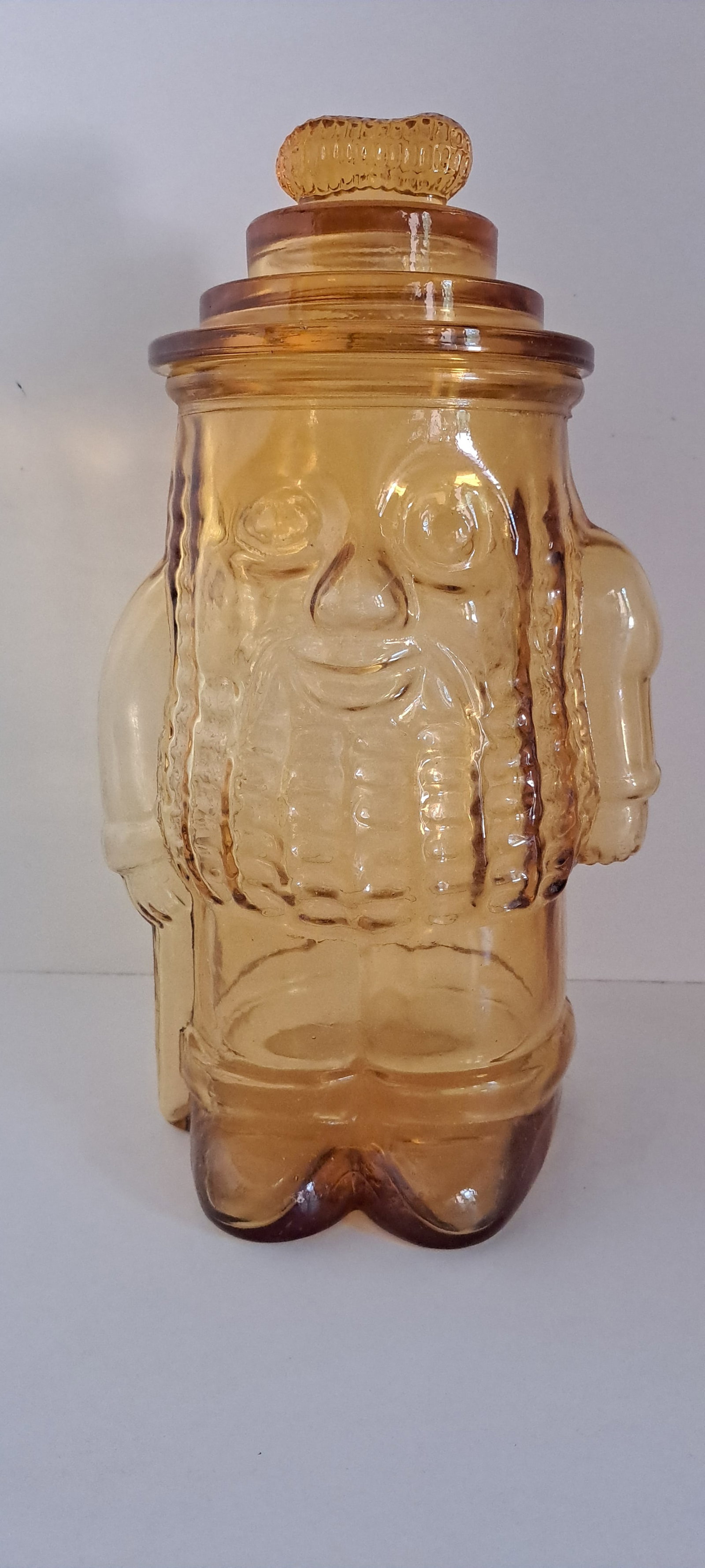 Mr. Peanut glass jar: Glass counter jar, shaped like Mr. Peanut with peanut shaped handle on lid. Amber in color. This is a fantasy jar made in the 90's, not original. Very good condition. No chips or cracks. Approx. 13"