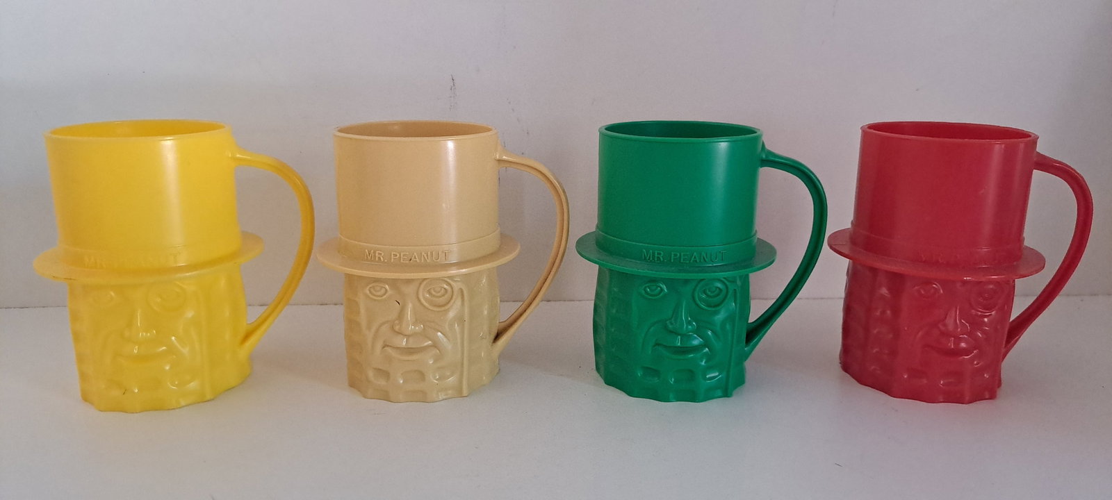 (4) Mr. Peanut cups: Yellow, tan, green ,& red. Plastic, Mr. Peanut cups. All in good condition. Each approx. 4" tall. Please see our shipping policy for options.