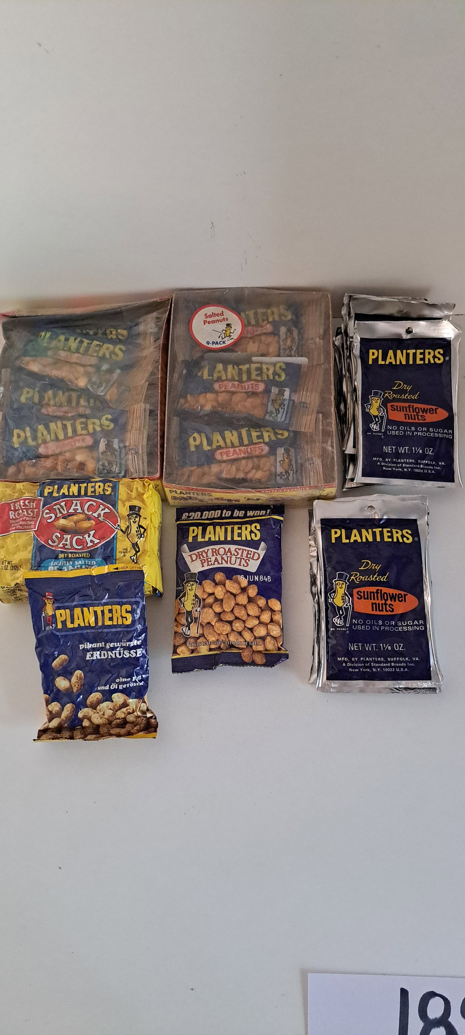 Planters Peanuts lot: Planters Munch'n go peanuts. Snack sack. Standard Brands German pack still sealed. 12 empty sunflower nuts bags, with t-shirt offer on back. All in good condition with storage wear. Please see our shi