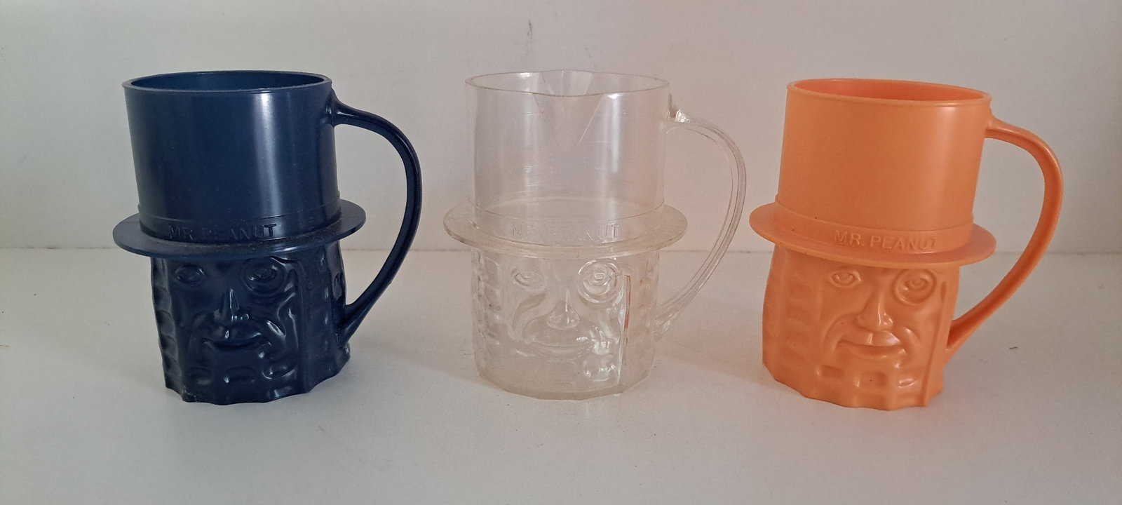 (3) Mr. Peanut plastic cups: 1- navy blue, 1- clear measuring cup, 1- peach color, All in good condition. Each approx. 4" tall. Please see our shipping policy for options.