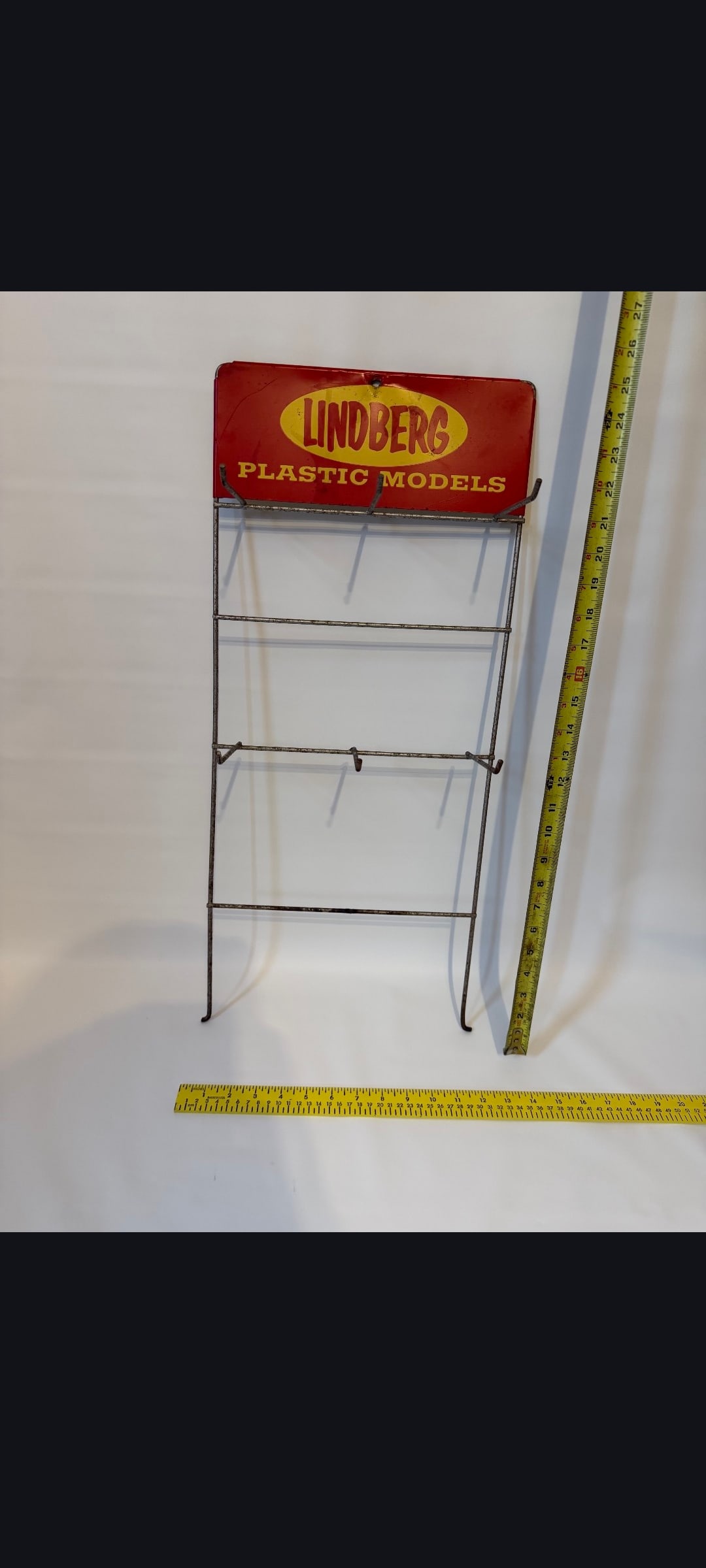 Lindberg Plastic Models rack: Lindbergs Plastic Models, rack with metal sign. Minor wear. Approx. 12" x 25". Please see our shipping policy for options.