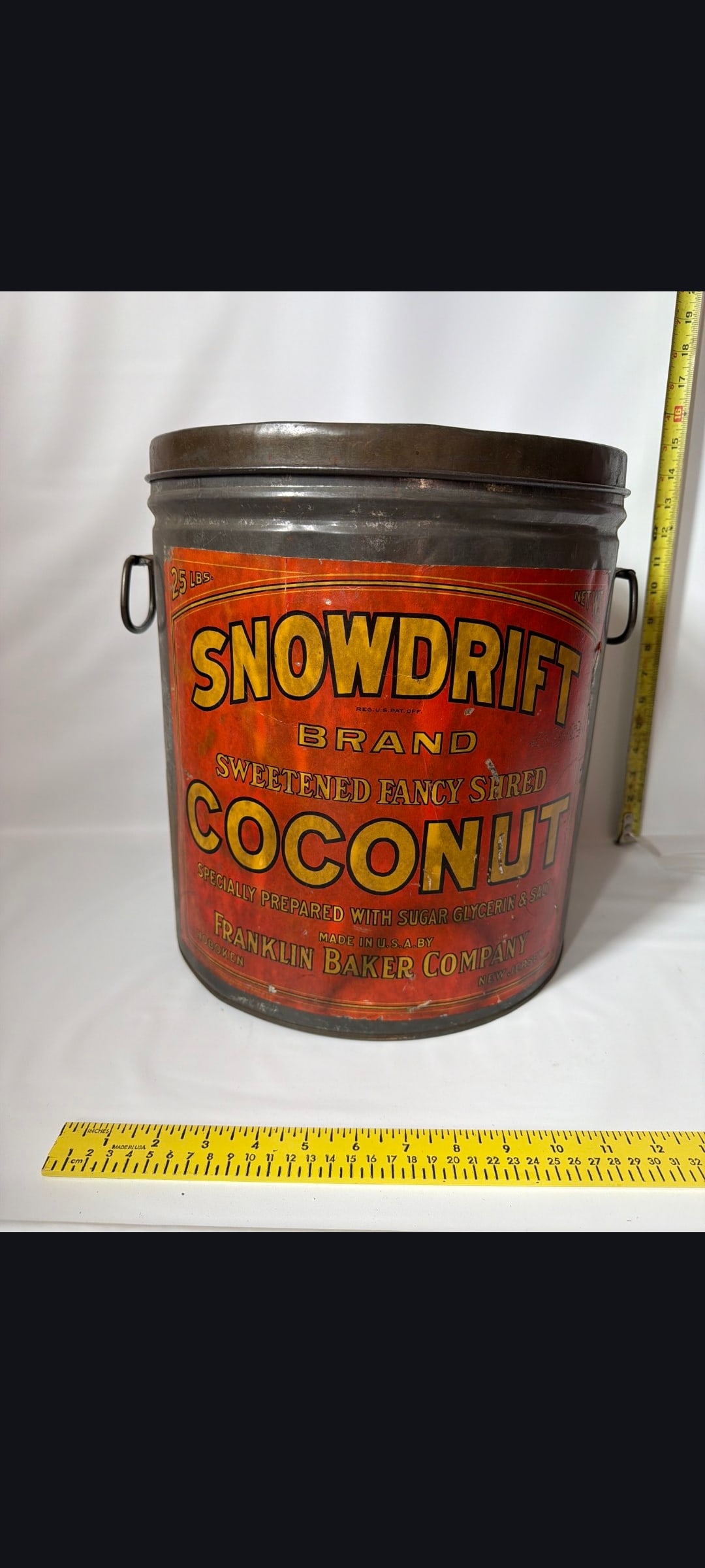 Snowdrift coconut tin: Snow drift coconut tin, Franklin Baker Company, Hoboken, NJ. copyright 1920, 25 lb. with paper label, and lid. Minor wear. Please see our shipping policy for options.