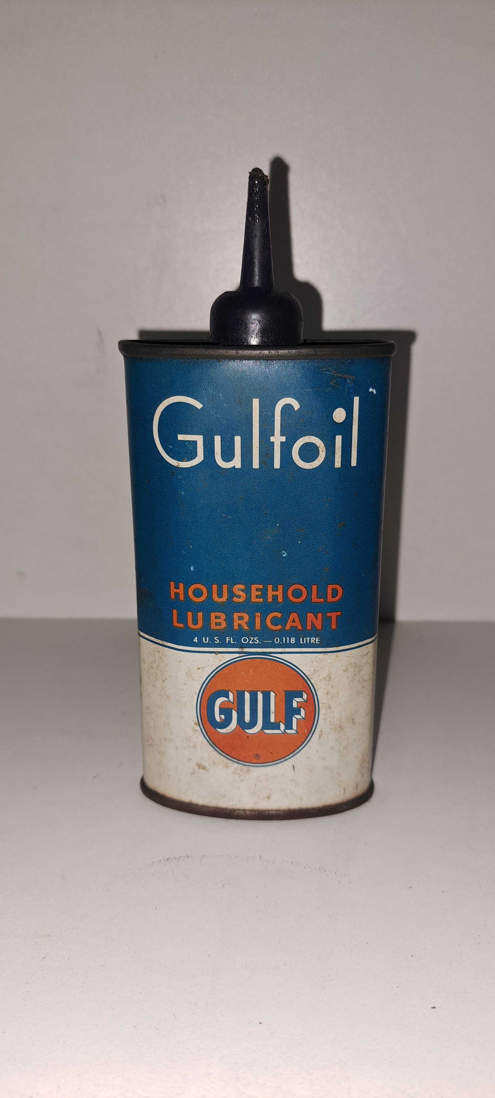 GULF oil tin: Small, GULFoil, 4 ounce, household lubricant, tin can. Plastic top. Approx. 6" tall. Dent on back, minor wear. Please see our shipping policy for options.