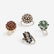 A group of four gem-set rings,