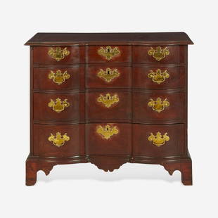 A Chippendale carved mahogany block-front chest of drawers Boston, MA, circa 1770: A Chippendale carved mahogany block-front chest of drawers Boston, MA, circa 1770 Top with chamfered edges, four graduated drawers with brass escutcheons and pulls, shaped apron, bracket feet. (H: