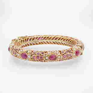 A 14K Yellow Gold, Pearl, and Ruby Bracelet: A 14K Yellow Gold, Pearl, and Ruby Bracelet A 14K yellow gold bangle bracelet made in India, set with eight cabochon rubies each measuring approximately 6.60mm x 5.20mm, one hundred four round-cut rub