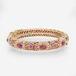 A 14K Yellow Gold, Pearl, and Ruby Bracelet: A 14K Yellow Gold, Pearl, and Ruby Bracelet A 14K yellow gold bangle bracelet made in India, set with eight cabochon rubies each measuring approximately 6.60mm x 5.20mm, one hundred four round-cut rub