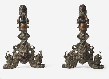 A large pair of Renaissance Revival bronze andirons, second half 19th century Surmounted with: A large pair of Renaissance Revival bronze andirons, second half 19th centurySurmounted with lions supporting armorial shields, above grotesque masques flanked by stylized lions with exaggerated