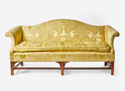 A Chippendale style mahogany camelback sofa with yellow silk damask upholstery, 20th century With: A Chippendale style mahogany camelback sofa with yellow silk damask upholstery, 20th century With arched backrest, scrolled arms, on straight molded legs with stretchers, with carved brackets. H: 35 i