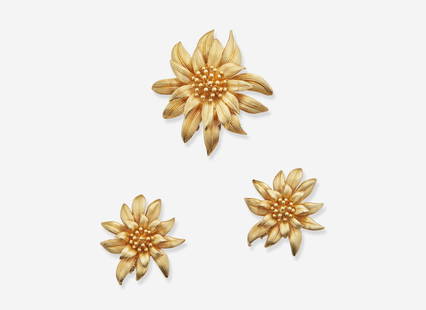 A 14K Yellow Gold Cartier Jewelry Suite: A 14K Yellow Gold Cartier Jewelry SuiteA suite of jewelry by Cartier, including a brooch and matching pair of ear clips, each piece crafted from textured 14K yellow gold to depict a flower in