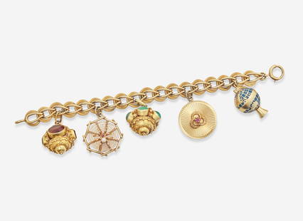 A 14K Yellow Gold Charm Bracelet: A 14K Yellow Gold Charm BraceletA 14K yellow gold charm bracelet with five charms, including a 14K yellow gold charm designed as a globe that spins, a 14K yellow gold circular charm set with a