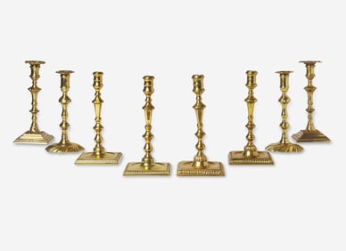 A group of eight Chippendale brass candlesticks, England, late 18th century
