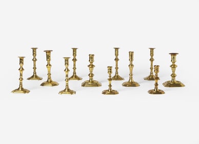 A group of twelve Chippendale octagonal or notched base brass candlesticks, England, late 18th