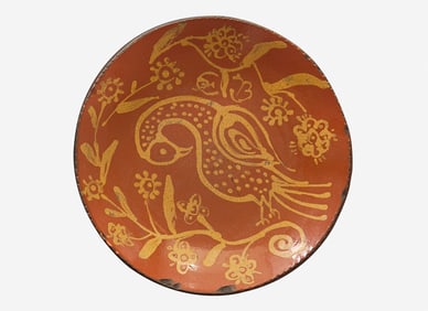 A glazed and slip-decorated redware plate, After Benjamin Bergey (1797-1854), Franconia Township,