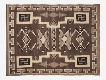 A large Navajo woven rug with whirling logs, early 20th century