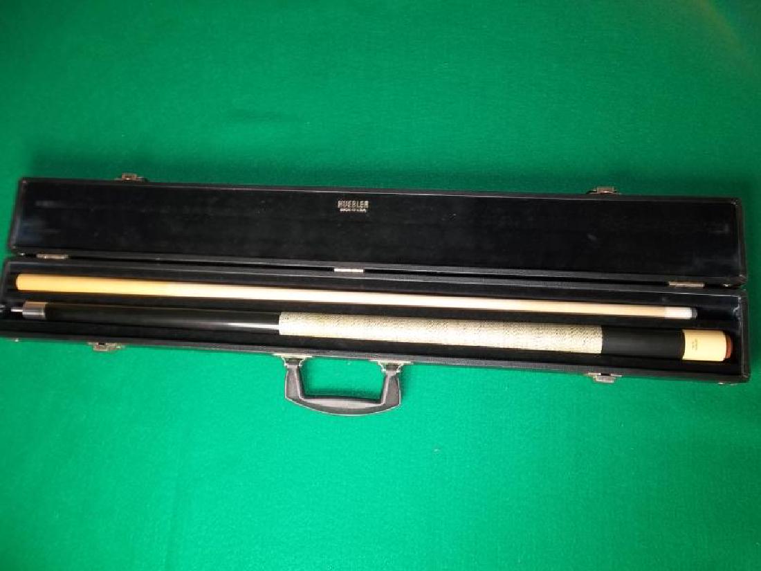 Huebler Pool Cue, 2 piece, 58", wrap is dirty,: Huebler Pool Cue, 2 piece, 58", wrap is dirty, scratches on forearm, hard black Huebler case with handle, case is worn, 31.25" l,scratches on forearm, hard black Huebler case with handle, case is worn